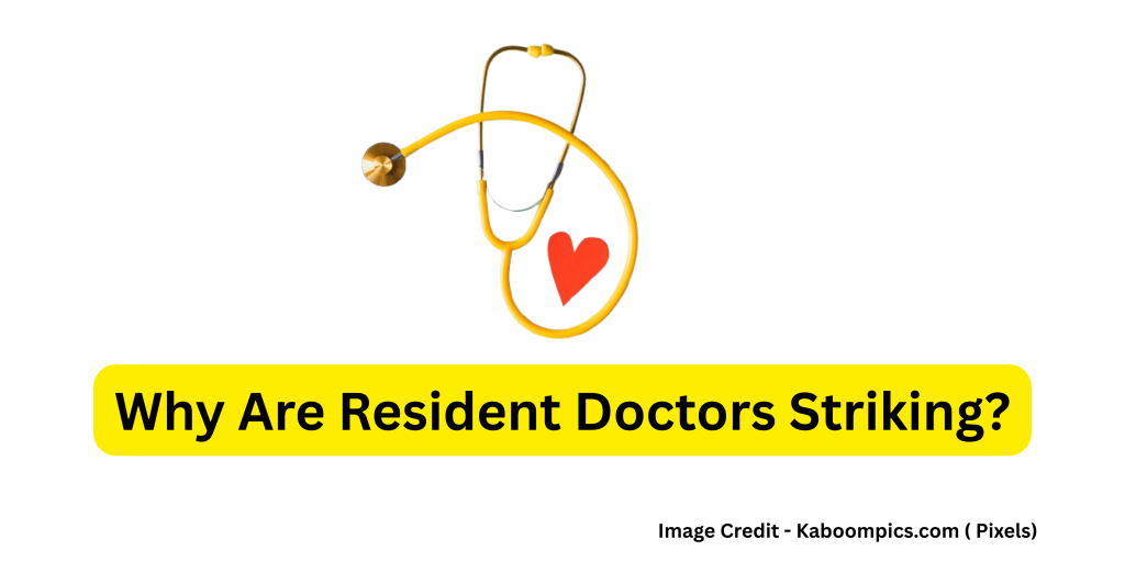 Resident doctors in England holding protest signs during a strike over pay dispute.

